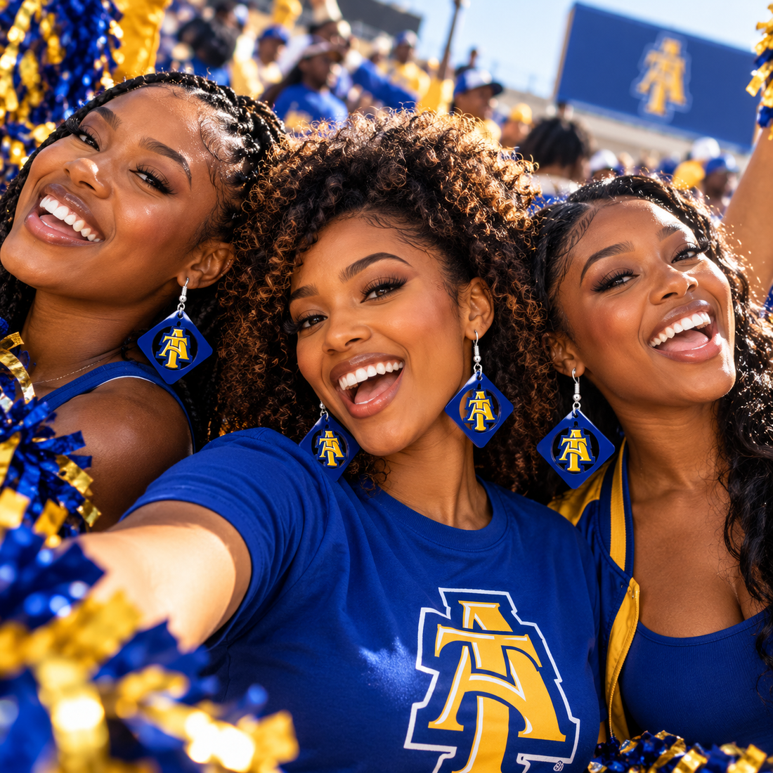 Friends wearing blue and gold diamond swing earrings at an HBCU homecoming game day